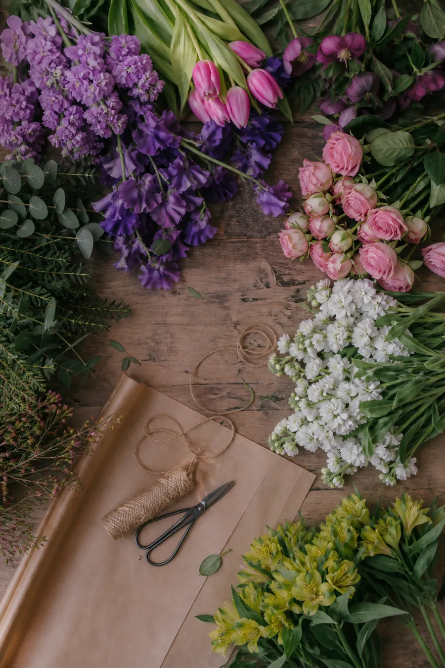 Flores ordenadas por color sobre una mesa de florería